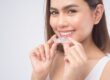 woman holding Invisalign clear braces